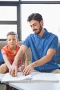 Teacher assisting blind student in library Royalty Free Stock Photo