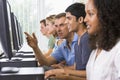 Teacher assisting college student on computers