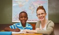 Teacher assisting little boy with homework in classroom Royalty Free Stock Photo