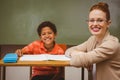 Teacher assisting little boy with homework in classroom Royalty Free Stock Photo