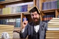 Teacher with beard with opened book on his head