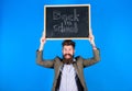 Teacher bearded man holds blackboard with inscription back to school blue background. Teaching stressful occupation. Do