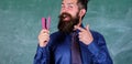 Teacher bearded man with stapler chalkboard background. Prepare for school season buy stationery. Man smiling hold