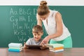 Teacher With Boy Using Digital Tablet In Classroom Royalty Free Stock Photo