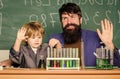 Teacher and child test tubes. Perseverance pays off. Chemical experiment. Symptoms of ADHD at school. Schoolboy cute Royalty Free Stock Photo