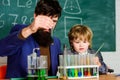 Teacher and child test tubes. School lesson. Perseverance pays off. Chemical experiment. Symptoms of ADHD at school Royalty Free Stock Photo