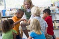 Teacher and children looking at bird's nest