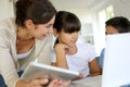 Teacher and children using laptop and tablet Royalty Free Stock Photo