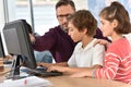 Teacher with children working on computer Royalty Free Stock Photo