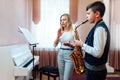 Teacher claps instead of a metronome for a student on saxophone in music lesson that focuses on playing Royalty Free Stock Photo