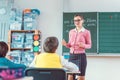 Teacher in class with fourth grade students in front of black board Royalty Free Stock Photo