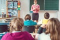 Teacher in class with fourth grade students in front of black board Royalty Free Stock Photo