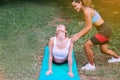 Teacher coaching to woman doing yoga at public park in the morning,Exercise and workout class concept Royalty Free Stock Photo