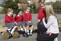 Teacher Comforting Victim Of Bullying In Playground Royalty Free Stock Photo