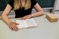 Teacher at the desk in the classroom