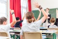 Teacher educate or teaching a class of pupils in school Royalty Free Stock Photo