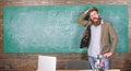 Teacher or educator welcomes students while stands near chalkboard with inscription back to school. Invite to school Royalty Free Stock Photo