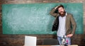 Teacher or educator welcomes students while stands near chalkboard with inscription back to school. Invite to school Royalty Free Stock Photo