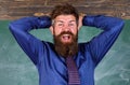 Teacher etiquette tips modern education professional. Man bearded teacher or educator hold head chalkboard background Royalty Free Stock Photo