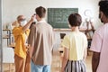 Teacher examining the students before lesson