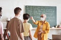 Teacher examining students before lesson