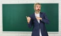 Teacher explain topic. Man teacher in front of chalkboard. Have good grade point average in high school. Teacher friend
