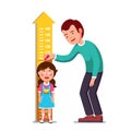 Teacher or father measuring girl kid height Royalty Free Stock Photo