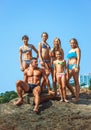 Teacher on fitness with the pupils on a beach