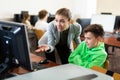 Teacher frustrated by misbehavior of her pupil during computer science lesson