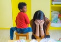 Teacher get headache with two naughty kids in classroom at kindergarten school