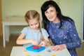 A teacher and girl solve mathematical puzzle. Royalty Free Stock Photo