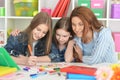 Teacher with girls drawing together at art class Royalty Free Stock Photo