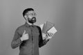 Teacher with glasses, organizer and thumbs up. Man with beard and books. Professor with smiling face expression