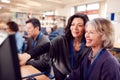 Teacher With Group Of Mature Adult Students In Class Working At Computers In College Library Royalty Free Stock Photo