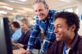 Teacher With Group Of Mature Adult Students In Class Working At Computers In College Library Royalty Free Stock Photo