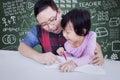 Teacher guide a little girl to learn Royalty Free Stock Photo