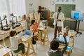 Teacher Guiding Students in Classroom With Computers Royalty Free Stock Photo