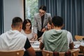 Teacher guiding students during a collaborative classroom session Royalty Free Stock Photo