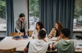 Teacher guiding students during a collaborative group study session Royalty Free Stock Photo