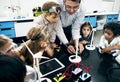 Teacher hands turning on solar windmill energy produce