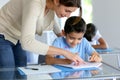 Teacher helping children with lesson Royalty Free Stock Photo