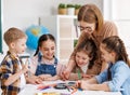 Teacher helping children with schoolwork Royalty Free Stock Photo