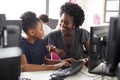 Teacher Helping Female High School Student Working at Screen In Computer Class Royalty Free Stock Photo