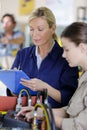 Teacher helping female trainee engineer