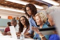 Teacher Helping Group Of Retired Senior Women Attending IT Class In Community Centre Royalty Free Stock Photo