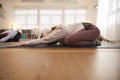 Teacher Helping Group Stretching On Exercise Mats In Yoga Or Fitness Class Inside Community Center Royalty Free Stock Photo