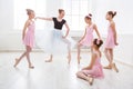 Teacher helping her students during dance class