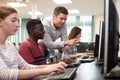 Teacher Helping Male High School Student Working In Computer Class Royalty Free Stock Photo