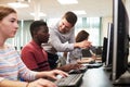 Teacher Helping Male High School Student Working In Computer Class Royalty Free Stock Photo