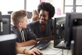 Teacher Helping Male High School Student Working at Screen In Computer Class Royalty Free Stock Photo